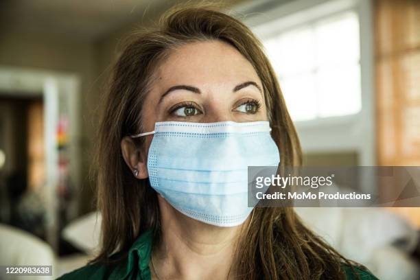 woman wearing surgical mask - covid stay at home order stock pictures, royalty-free photos & images