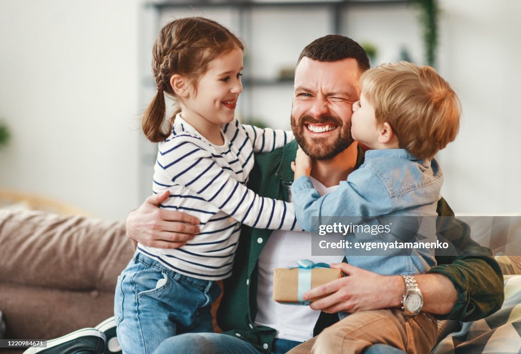 Happy father getting congratulations from kids