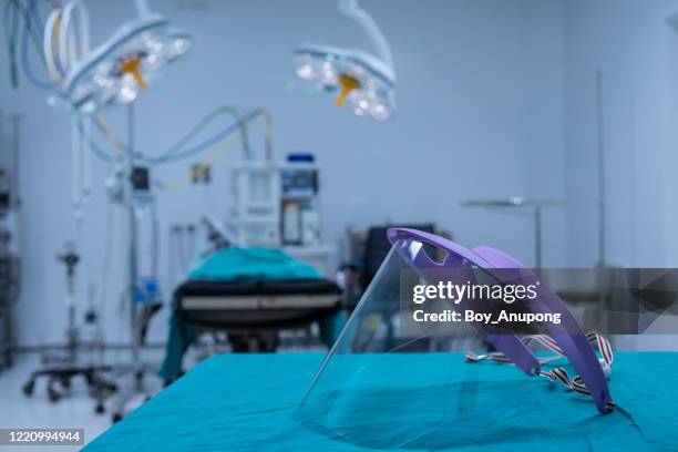 a face shield prepare on the table before surgery in operating room. - before covid stock pictures, royalty-free photos & images