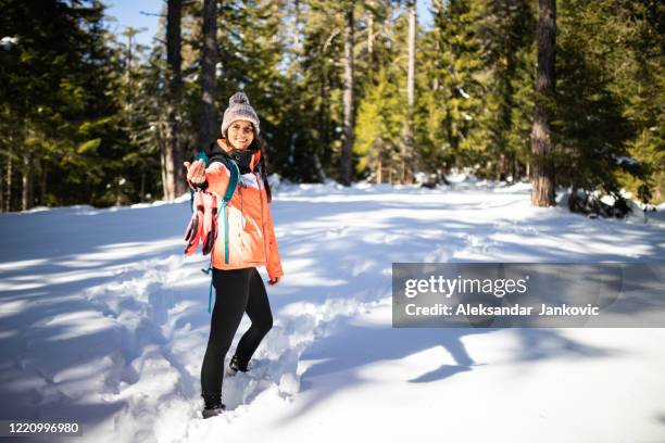 a young woman in hiking equipment beckoning - beckoning stock pictures, royalty-free photos & images