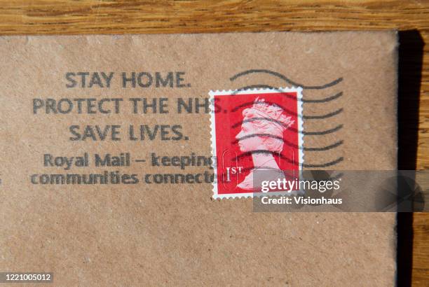 Letter with the franking stamp encouraging people to Stay Home, Protect the NHS and Save Lives on April 24, 2020 in Manchester, England. The British...