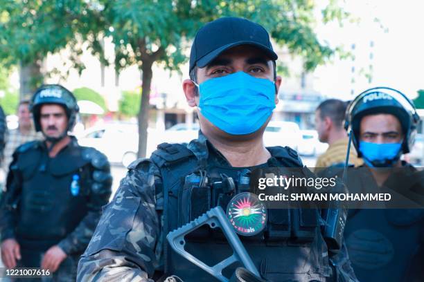 Kurdish riot police, some wearing protective masks due to COVID-19, stand guard during a demonstration to denounce the Turkish assault in northern...