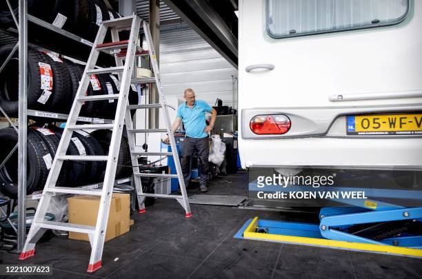 An employee check a caravan at a dealer ship in Almere on June18 as sales of caravans and motorhomes has increased due to the novel coronavirus,...