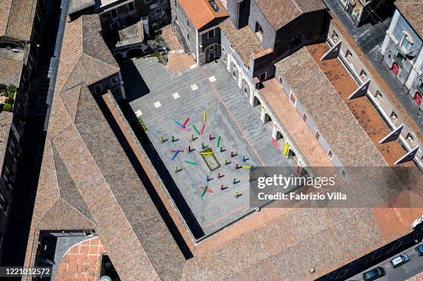 Aerial view of the empty Palazzo della Cultura with an artistic setting in the middle of the courtyard from a Catania Coast Guard helicopter flight...