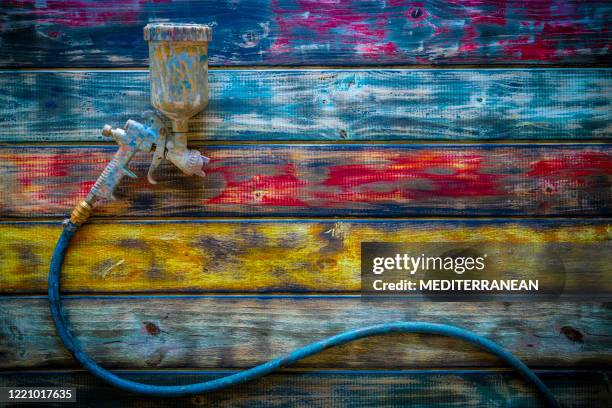 paint spray gun airbrush used dirty on grunge colorful wooden background - airbrush stock pictures, royalty-free photos & images