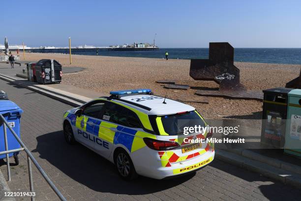 Police car patrols Brighton beach on April 25, 2020 in Brighton, United Kingdom. The British government has extended the lockdown restrictions first...