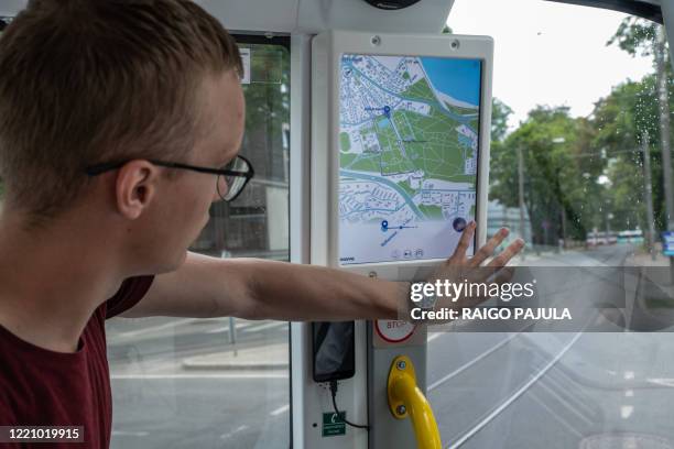 Passenger looks at a map on a self-driving bus being tested out on tourist route in Tallin, Estonia, on June 16, 2020. - The project is a joint...