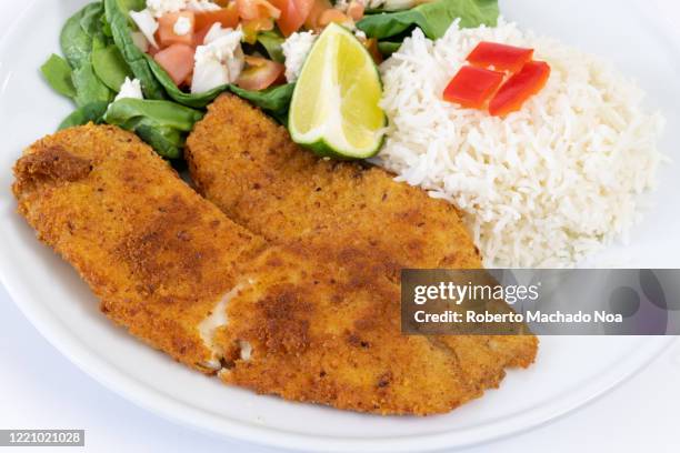 cooked tilapia fish fillet served with salad - breaded stock pictures, royalty-free photos & images
