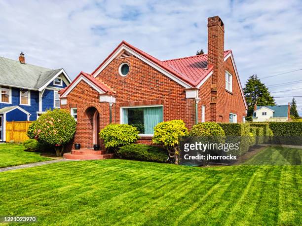 small red brick house with green grass - house stock pictures, royalty-free photos & images