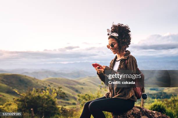 het meisje dat van de tiener celtelefoon in openlucht gebruikt - woman smartphone nature stockfoto's en -beelden