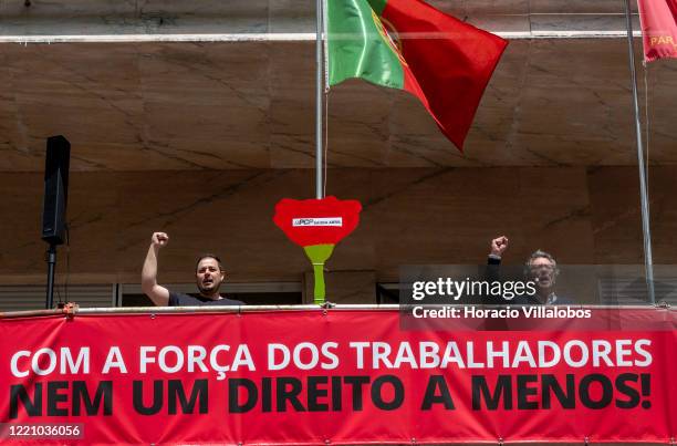 Members of the Portuguese Communist Party raise their fists while singing 'Grândola, Vila Morena', Zeca Afonso's song on April 25, 2020 in Lisbon,...