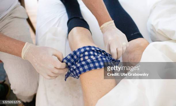 In this photo illustration an orderly makes an envelope at a knie on June 11, 2020 in Bonn, Germany.