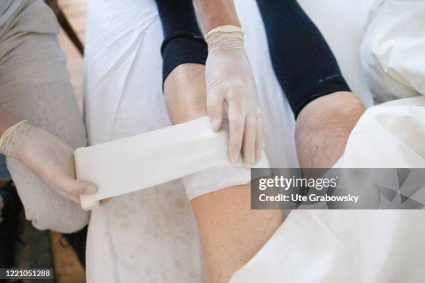 In this photo illustration an orderly makes an envelope at a knie on June 11, 2020 in Bonn, Germany.