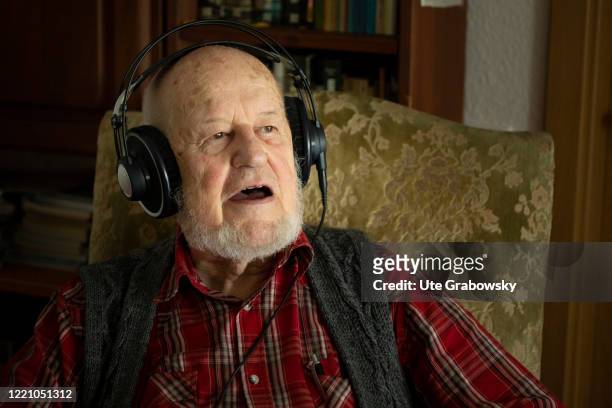 In this photo illustration an old man is singing wearing headphones on June 11, 2020 in Bonn, Germany.