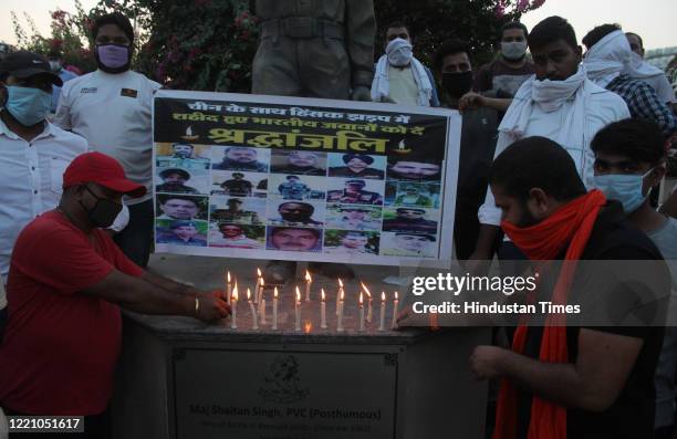 Shiv Sena supporters organise a candlelight vigil to pay tribute to the martyrs of Galwan Valley, at Rezangla Chowk on June 18, 2020 in Gurugram,...