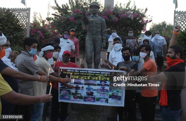 Shiv Sena supporters organise a candlelight vigil to pay tribute to the martyrs of Galwan Valley, at Rezangla Chowk on June 18, 2020 in Gurugram,...