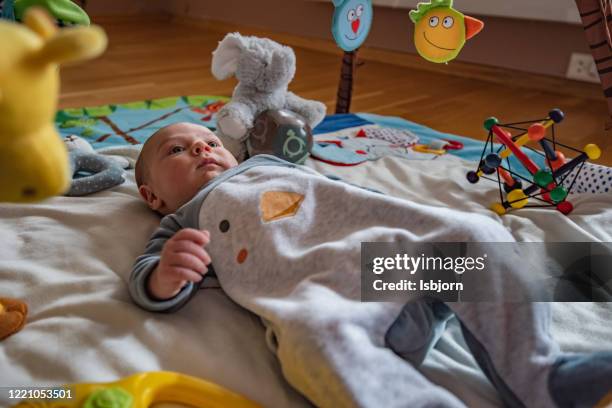 baby boy in baby gym. - baby kicking stock pictures, royalty-free photos & images