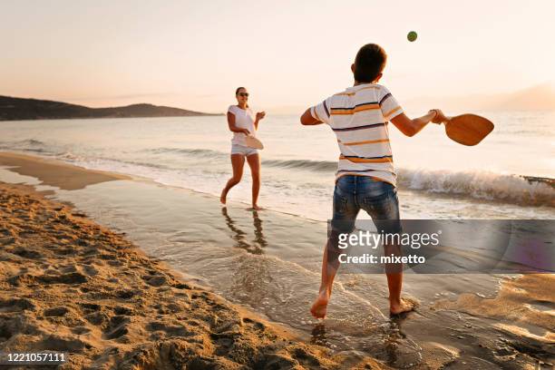 vänner spelar beachtennis - two tennis rackets bildbanksfoton och bilder