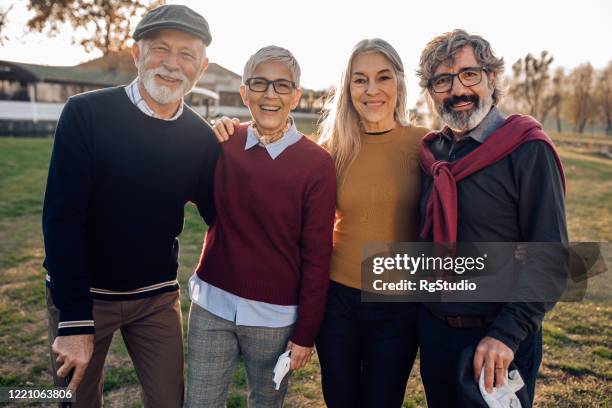 portrait of happy seniors on a golf course - old golfer stock pictures, royalty-free photos & images