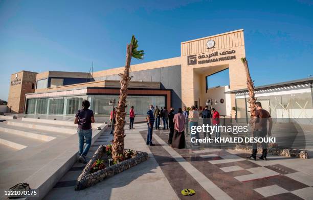 Tourists wait outside the museum in the Red Sea Egyptian resort of Hurghada on June 18, 2020. - Egypt will reopen its airports on July 1 and begin...