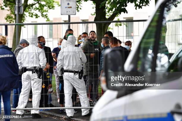 Police forces wearing full protective suits prepare to enter the high-rise apartment building, as tensions between residents and authorities rise,...