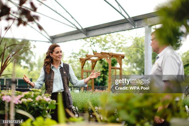 Catherine, Duchess of Cambridge talks to Martin and Jennie Turner, owners of the Fakenham Garden Centre in Norfolk, during her first public...