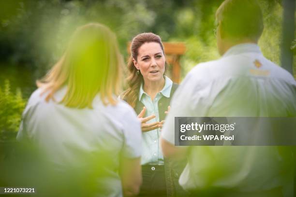 Catherine, Duchess of Cambridge talks to Martin and Jennie Turner, owners of the Fakenham Garden Centre in Norfolk, during her first public...