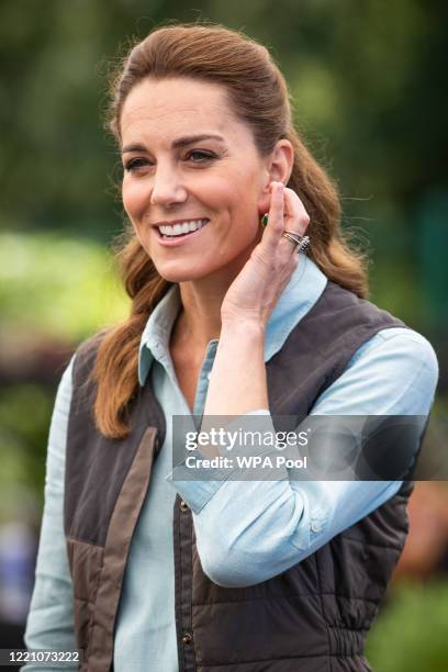 Catherine, Duchess of Cambridge talks to Martin and Jennie Turner, owners of the Fakenham Garden Centre in Norfolk, during her first public...