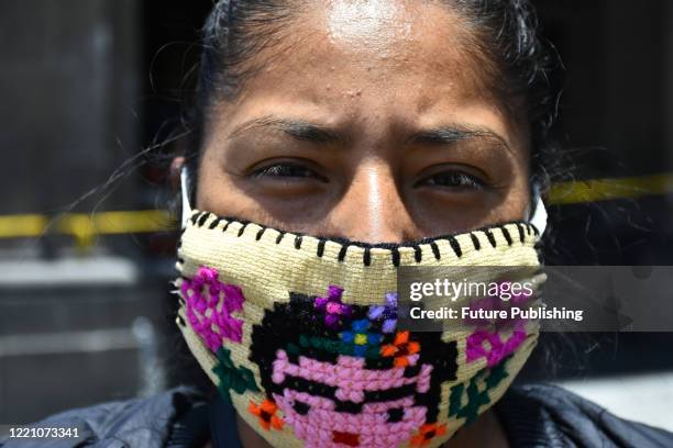 An indigenous merchant from Temascalcingo, Mexico State, offers handmade face masks, she was dedicates to the production of typical clothing, due the...