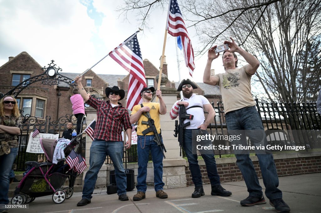 Protesters rally outside of the Minnesota governor's mansionto show their opposition to the stay at home order