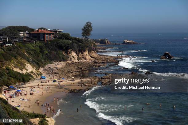 People are seen gathering on the Little Corona del Mar Beach on April 25, 2020 in Newport Beach, California. Southern California is expecting summer...