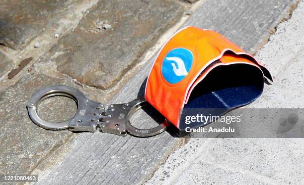 Handcuffs are displayed on the ground as police officers take part in a protest against accusations of racism in front of the Justice Palace in...