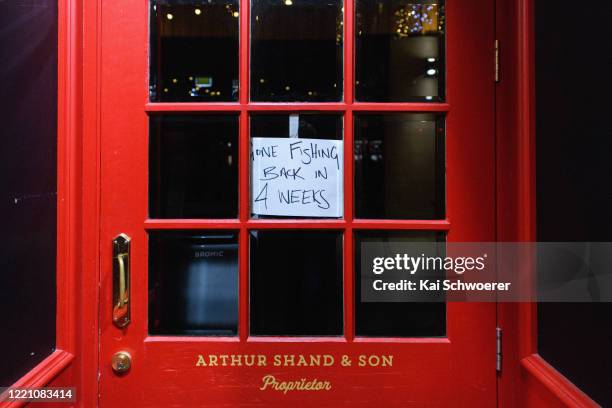 Sign saying gone fishing back in 4 weeks is seen at the Little Fiddle Irish Pub on the Terrace, one of the most popular socialising locations in the...