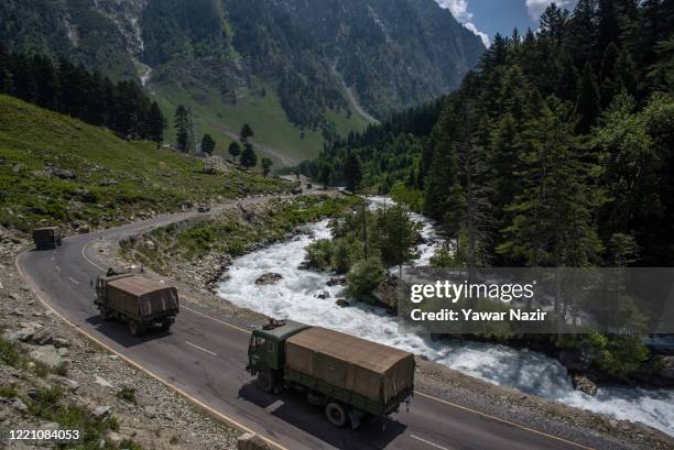 An Indian army convoy drives towards Leh, on a highway bordering China, on June 19, 2020 in Gagangir, India. As many as 20 Indian soldiers were...