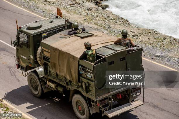 An Indian army convoy drives towards Leh, on a highway bordering China, on June 19, 2020 in Gagangir, India. As many as 20 Indian soldiers were...