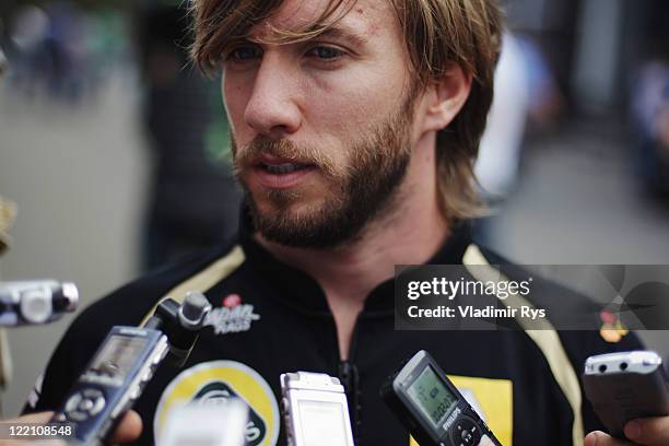 Nick Heidfeld of Germany and Renault is interviewed in the paddock by the media during previews to the Belgian Formula One Grand Prix at the Circuit...