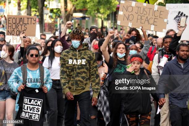 Crowd of about 200 protesters march from the so-called Capitol Hill Autonomous Zone to Seattle's West Precinct police station. Following the...