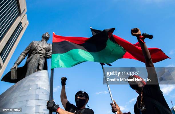 Protester chant near the Adam Clayton Powell Jr. Statue during a Juneteenth celebration on June 19, 2020 in New York City. Juneteenth commemorates...