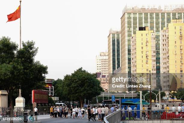 Citizens who visited or live near Xinfadi Market queue for a nucleic acid test on June 19, 2020 in Beijing, China. The authorities in Beijing have...