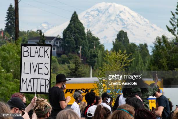 Protesters listen to speakers in Jimi Hendrix Park during the Freedom March & Celebration organized by King County Equity Now in Seattle, Washington...