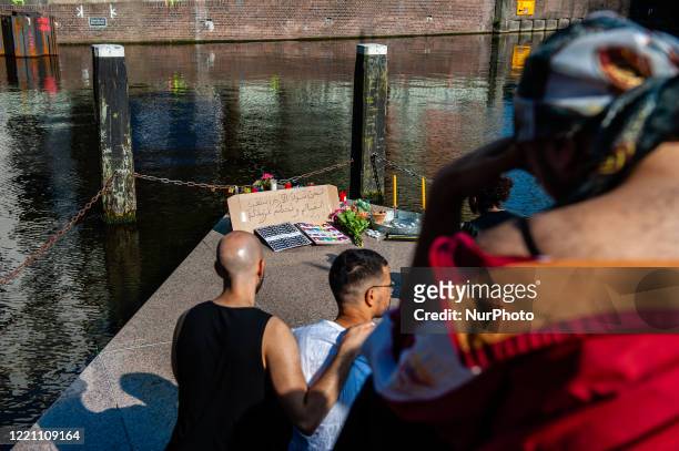 Couple of men are holding each other, during the Remembrance in Memory of Sarah Hegazy, that takes place in Amsterdam, on June 19th, 2020.