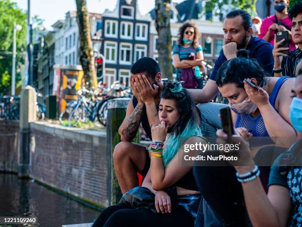 Some people are crying, during the Remembrance in Memory of Sarah Hegazy, that takes place in Amsterdam, on June 19th, 2020.