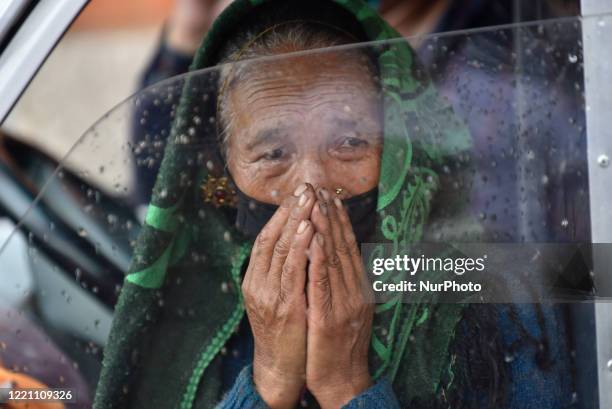 70yrs Koiku Maya Ghale leaves after carrying the dead body of her daughter for the final ritual at Tribhuvan International Airport, Kathmandu, Nepal...