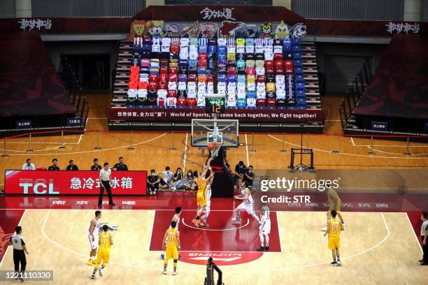 Players compete during the CBA basketball match between Nanjing Monkey Kings and Zhejiang Guangsha Lions in Qingdao in China's eastern Shandong...