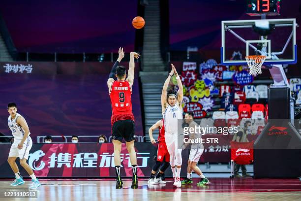 Li Muhao of Shenzhen Aviators takes a shot during the CBA basketball match between Suzhou Dragons and Shenzhen Aviators in Dongguan in China's...