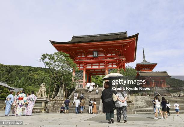 People visit Kiyomizu temple in Kyoto on June 20 the first weekend since Japan lifted its final advisories on inter-prefecture travel, based on the...