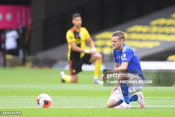 Leicester City's English striker Jamie Vardy takes a knee to show support for the Black Lives Matter movement and as a protest against racism before...