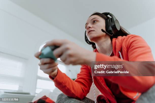 woman playing multiplayer online games - shooter online stock pictures, royalty-free photos & images