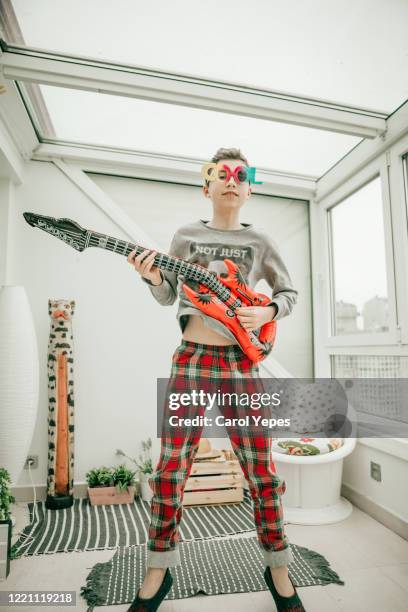 teenager boy plays plastic fake guitar with cool glasses - little punk stock pictures, royalty-free photos & images
