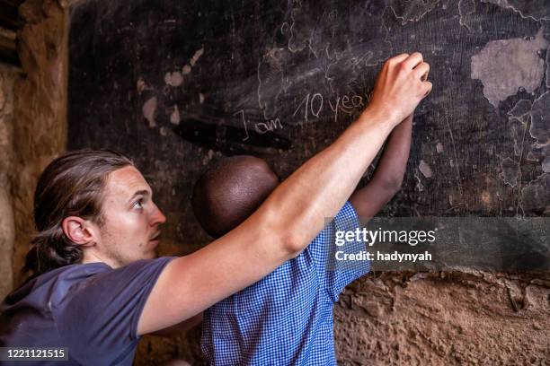 vrijwilliger onderwijs in afrika, weeshuis in kenia - boy gift stockfoto's en -beelden